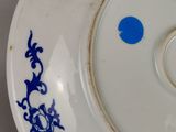 a white plate with a blue design on it