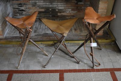 two leather stools sitting next to each other on the floor