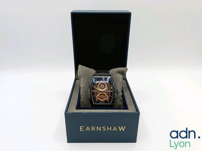 an image of a watch sitting in a box on a white surface