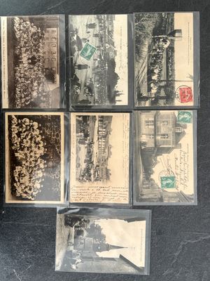 a lot of old black and white photos on the table