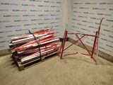 a pile of skis sitting on a pallet in front of a wall