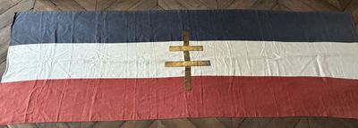 a bed with a red, white, and blue blanket on it
