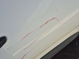 a white car with red marks on the side of it