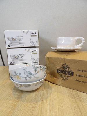 three bowls and a cup sitting on a table next to a box