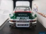 a model of a green and white car in a display case