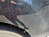 a reflection of a person on the side of a car