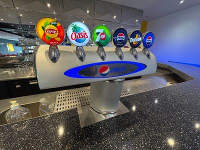 a bunch of beer taps on a counter in a restaurant