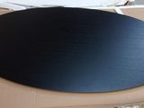 a black plate sitting on top of a cardboard box