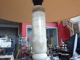 a large lamp that is on a pole in a room