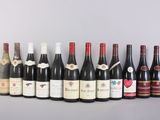 several bottles of wine are lined up in a row on a table