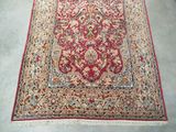 a red rug on the floor in a room