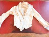 a white shirt on a red mat on the floor
