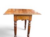 an old wooden table with turned legs on a white background