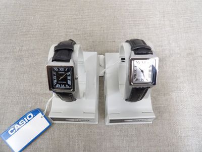 two watches that are on display on the table
