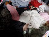 a suitcase full of clothes that is sitting on the floor