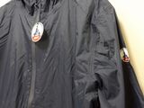 jacket hanging on a hanger in a room with a white wall