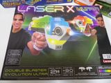 a box with a toy gun in it on a table