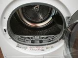 a washing machine with the door open on the floor
