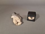 a small statue of a dog and a small box