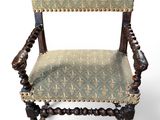 an old wooden chair with a green upholstered upholstered seat