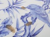 a blue and white plate with a bird on it