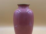 a purple vase that is sitting on a table