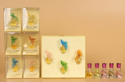 a lot of different perfumes in a box on the table
