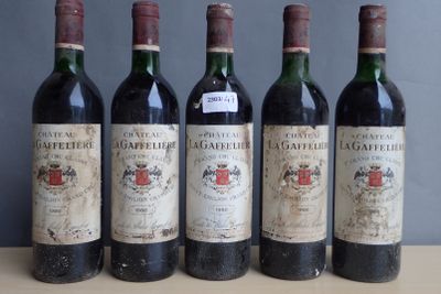 four bottles of wine are lined up on a table