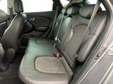 the back seats of a car are black and grey in color