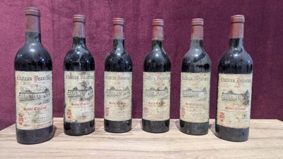 six bottles of wine are lined up on a wooden table