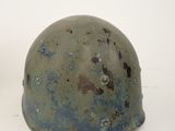 helmet with holes on it sitting on a white surface