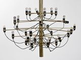 a large brass chandelier with twelve lights hanging from the ceiling