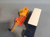 a toy truck and a toy crane next to each other