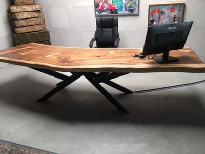 a wooden desk with a computer on top of it