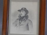 portrait d'un homme portant un chapeau et une veste, dans un cadre en bois