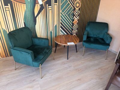 two chairs and a table in the corner of a room