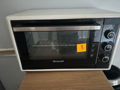 a toaster oven sitting on top of a wooden table