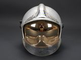 silver helmet with gold tinted goggles on a black background