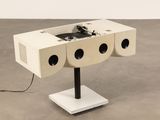 a white table with speakers and a record player on it