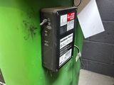 an image of a green trash can with a label on it