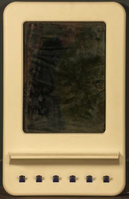 a small white computer sitting on a wooden table