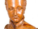 a wooden statue of a man with a hat on his head