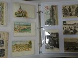 many old postcards on display in a binder