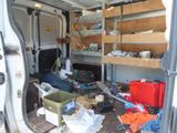 a white van that has a lot of clutter in it