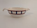 a close up of a white bowl with a red and blue stripe
