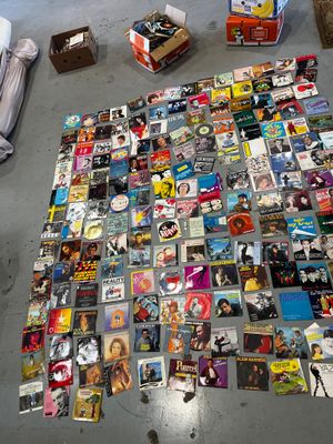 a large collection of dvds and cds on the floor