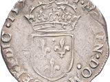 a silver coin with a crown on top of it