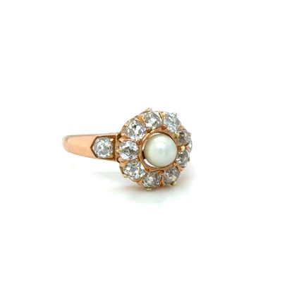 an image of a white pearl and diamond ring on a white background
