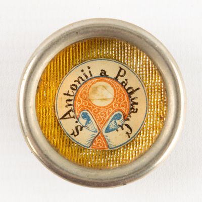 a button with a picture of a woman and a bird on it