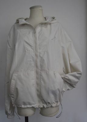 jacket on a mannequin stand with a white wall in the background